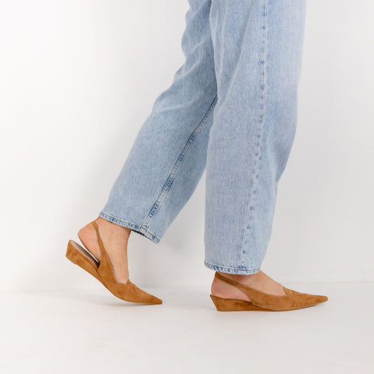Model wearing Triana Tobacco suede slingbacks with tailored trousers, by Estela