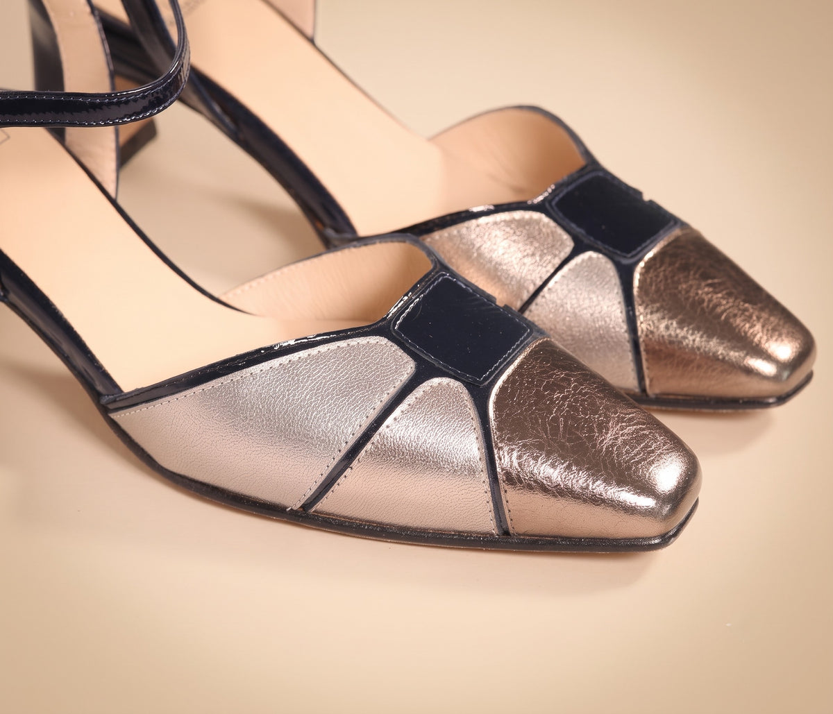 Moonlit in Málaga bronze metallic leather heel with navy patent accents, product shot on white background, by Estela