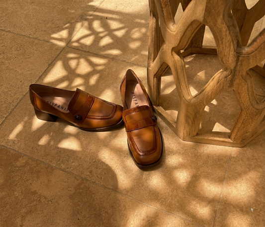 Tan leather buckle loafers, outdoor styled shot