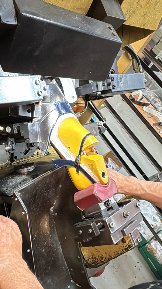Shoemaker shaping shoe on last during Spanish footwear manufacturing