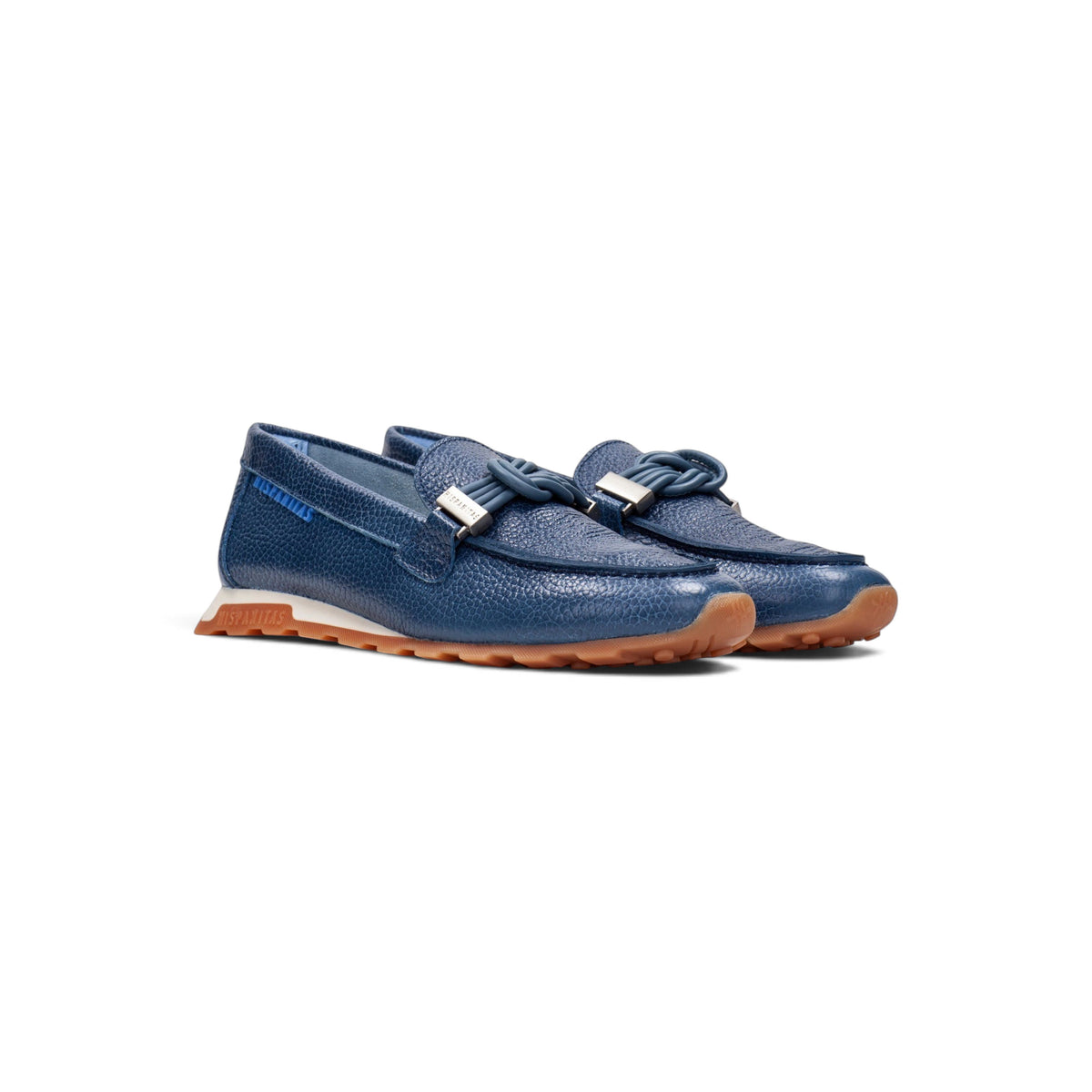Lucía Jean leather loafer, close-up hand holding shoe showing detail, by Estela