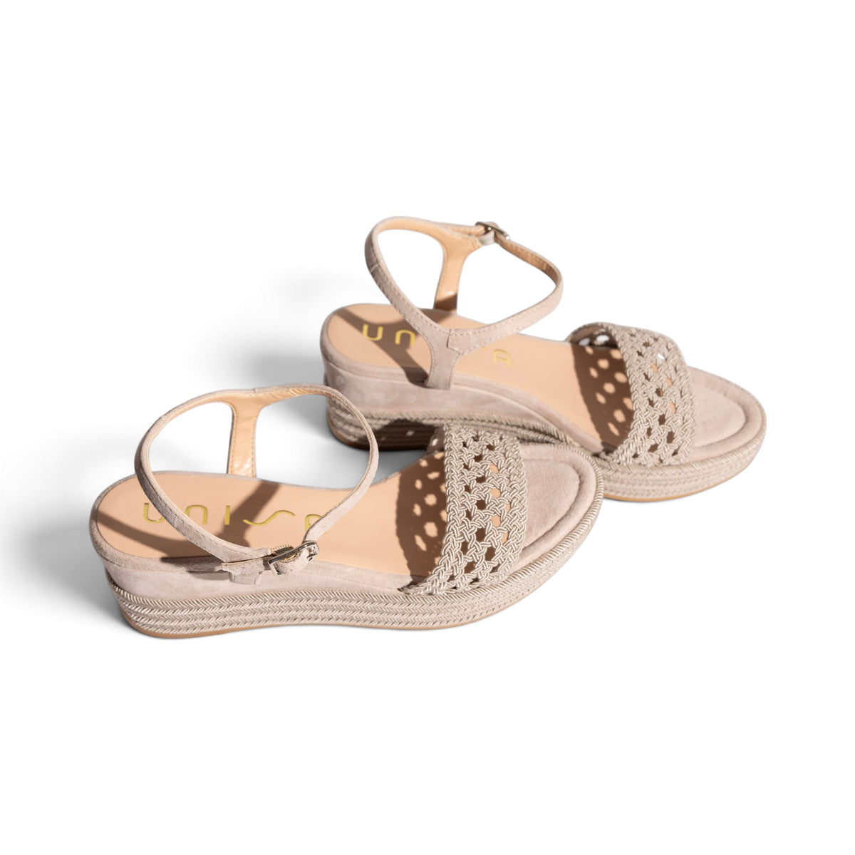 Model wearing Carmela Natural woven platform wedge sandals, lifestyle shot, by Estela