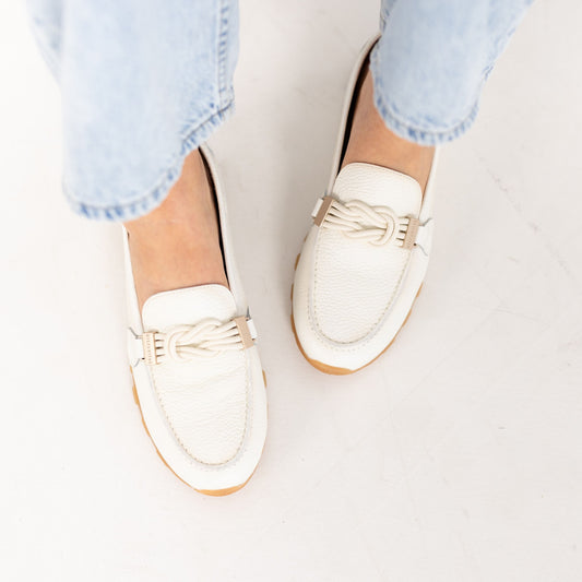 Model wearing Lucía Porcelain leather loafers, walking lifestyle shot, by Estela