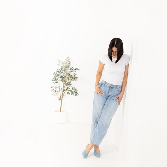 Model wearing Celia Blue Pearl leather slingback heels, full body in white outfit, by Estela
